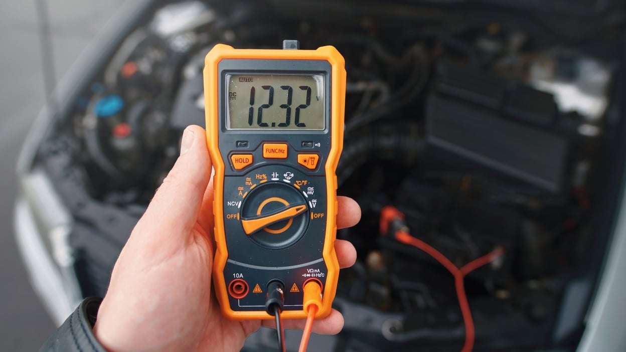 12v PitStop technician performing free battery diagnosis at a car in East of Kailash, South Delhi